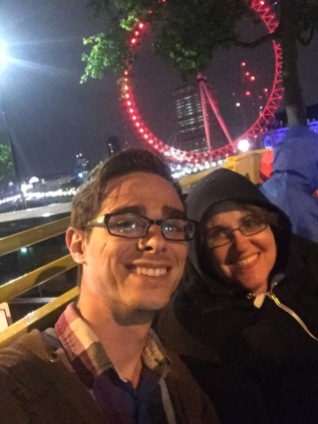 My aunt and I on a bus tour through London with the London Eye lit in red
