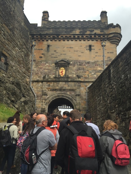Tourists crowd the path leading under the gatehouse into Edinburgh Castle