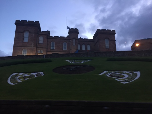 Well maintained landscaping on the hillside surrounding Inverness Castle at dusk
