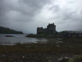 Eilean Donan Castle sits in a murky bay on a rainy day