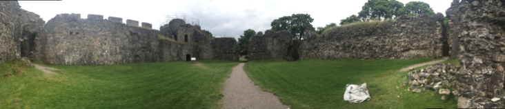 A pathway leading through the courtyard in Inverlochy Castle leading to a ruined gate